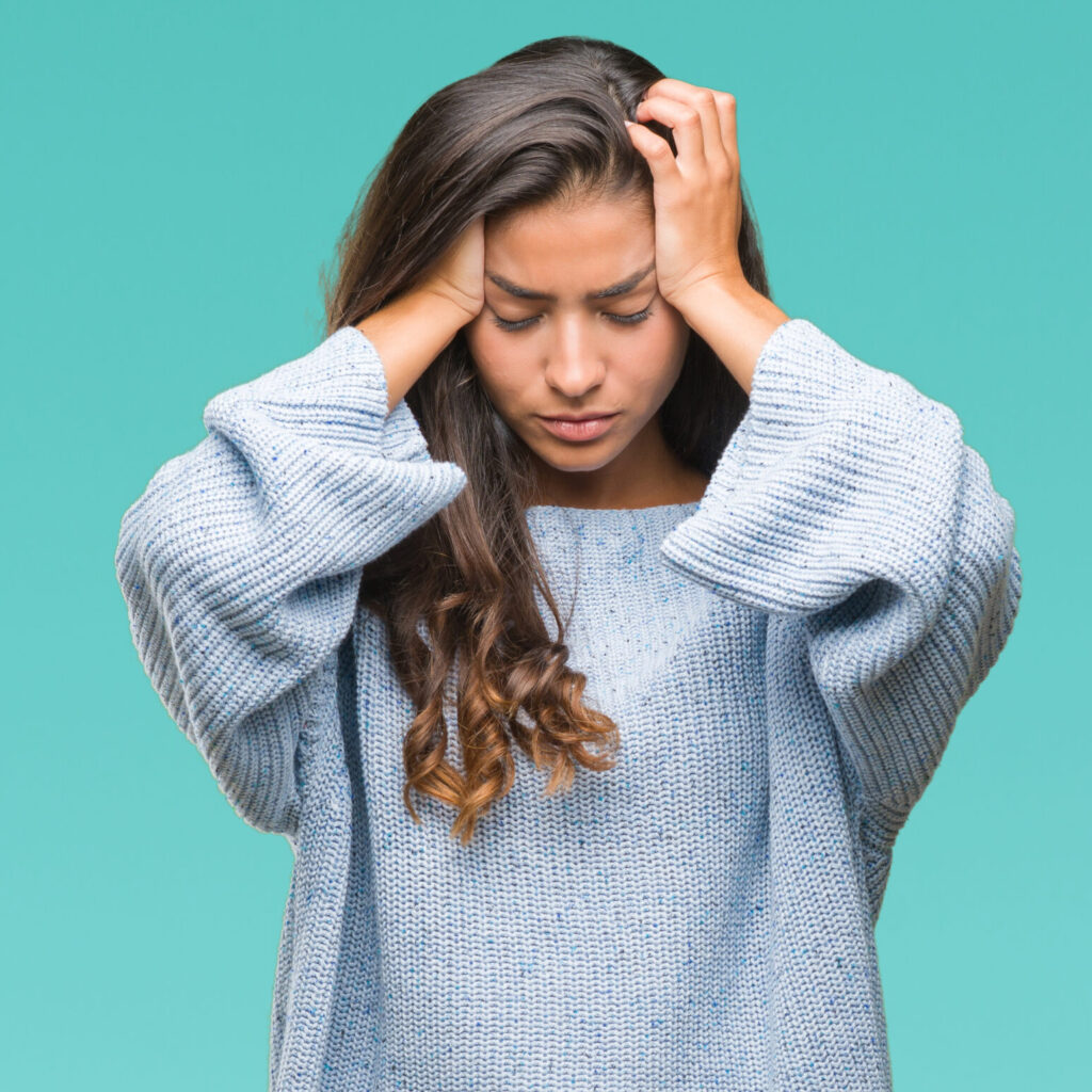 Woman with a headache holding her head